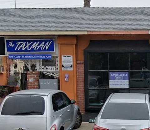 A small building with a sign that says "The Taxman" on it.