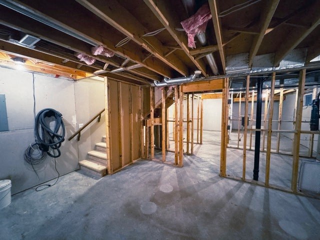 A room under construction with exposed wooden beams and unfinished walls.
