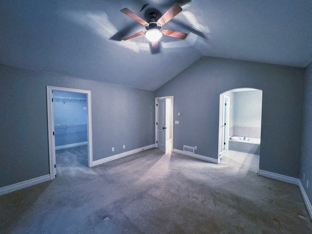 A room with a ceiling fan and three doors.
