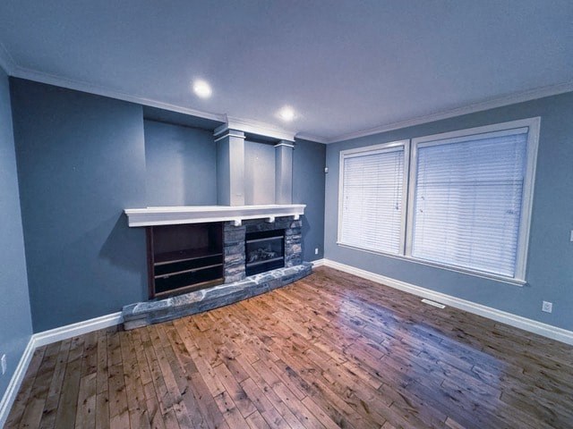 A room with a fireplace and wooden floors.