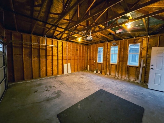 A room under construction with wooden walls and a black mat on the floor.