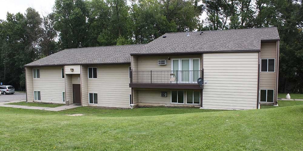 A two-story house with a balcony on the upper floor.