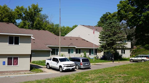A white car is parked in front of a house.