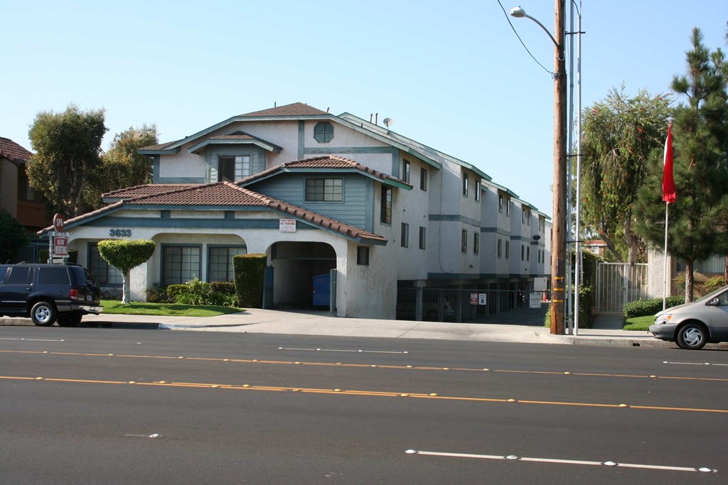 A grey building with a red roof and a flag on top.