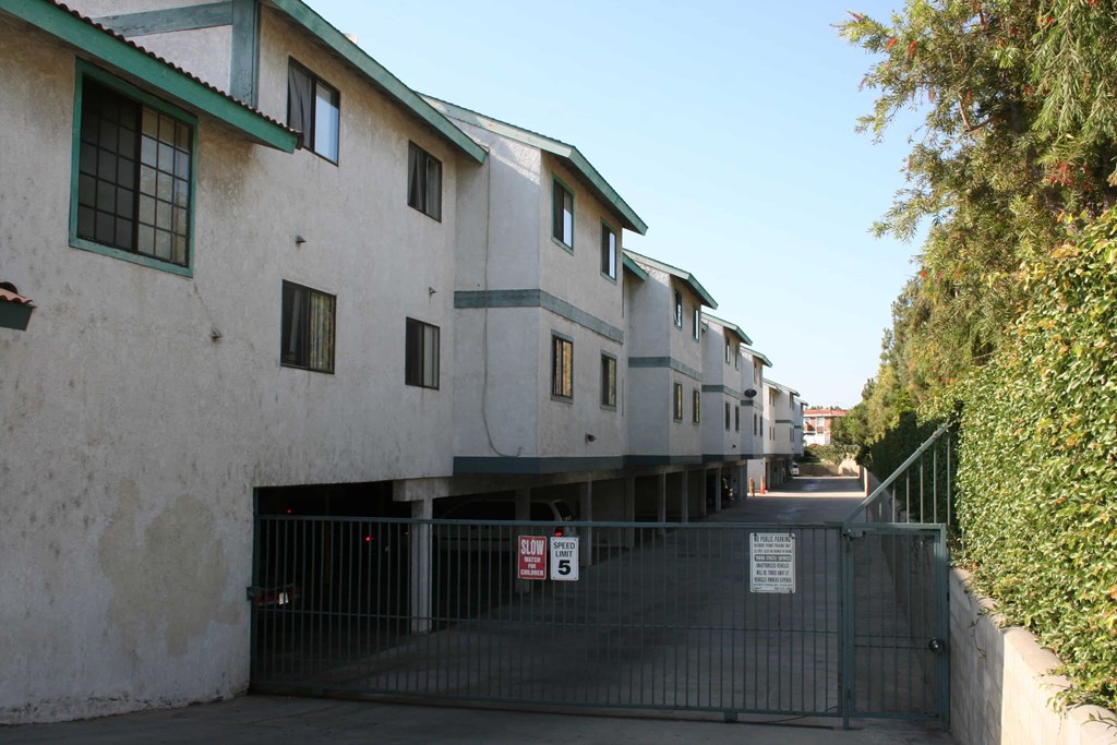 A row of houses with a gate in front.