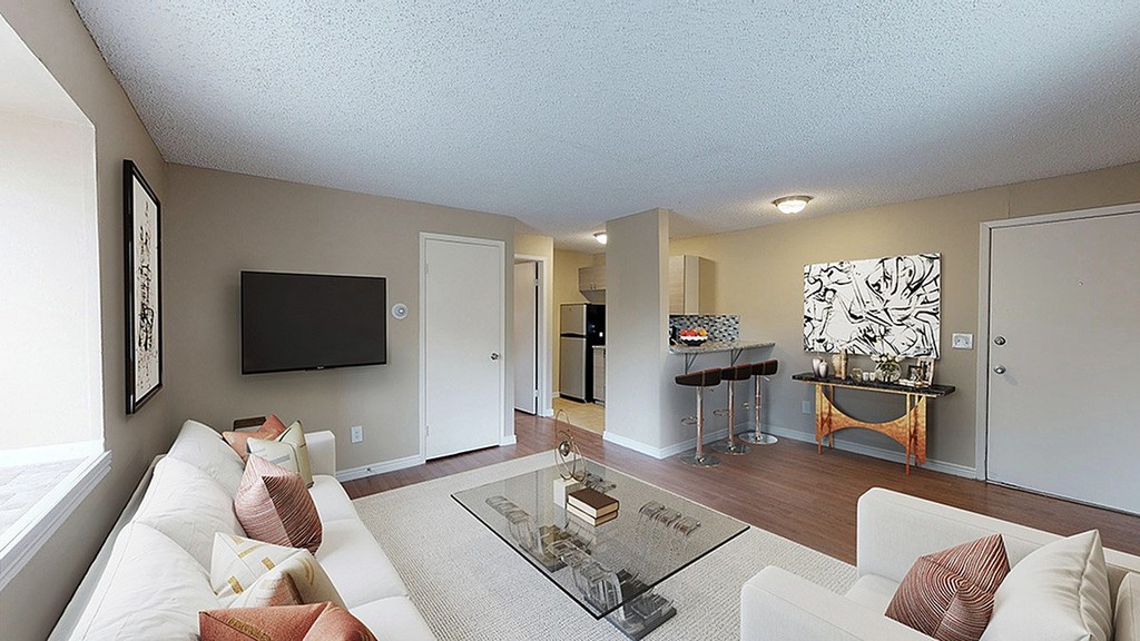 A white picket fence in front of a brick building.