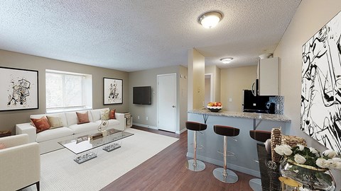 A living room with a white couch and a glass coffee table.