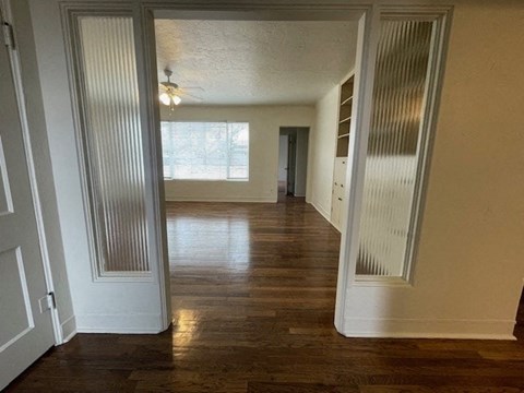 A room with wooden floors and white walls.