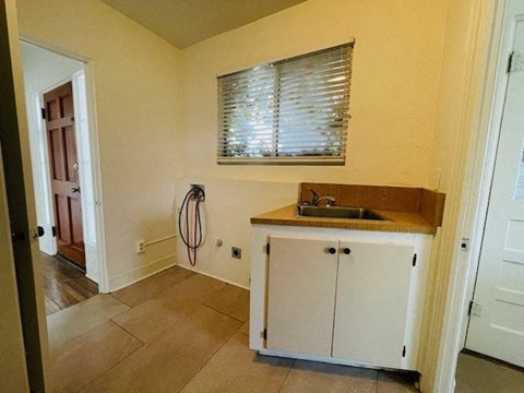 A kitchen with a sink and cabinets.