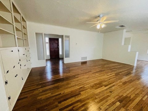 A room with wooden floors and white walls.