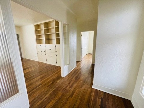 A room with wooden floors and white walls.