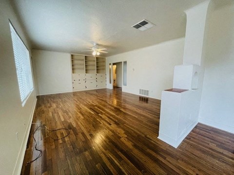 A room with wooden floors and white walls.