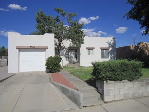 A white house with a brown garage door numbered 2503.