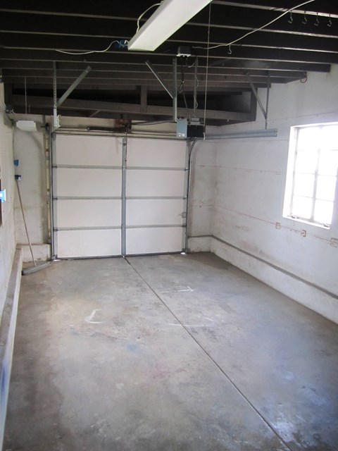 A garage with a white door and a window.