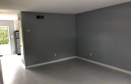 A room with grey walls and a white door.