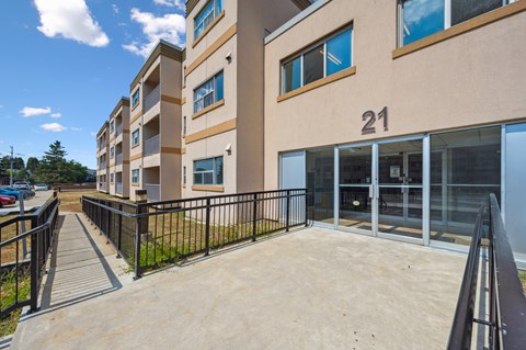 A building with the number 21 on it has a black fence around it.