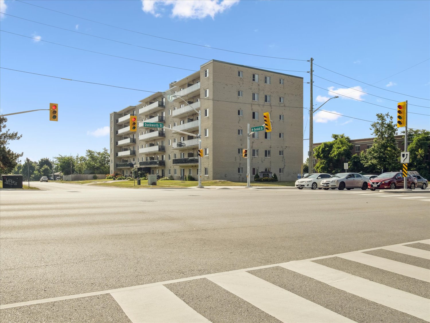 A large building with a parking garage in front of it.