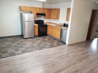 A kitchen with wooden cabinets and a refrigerator.