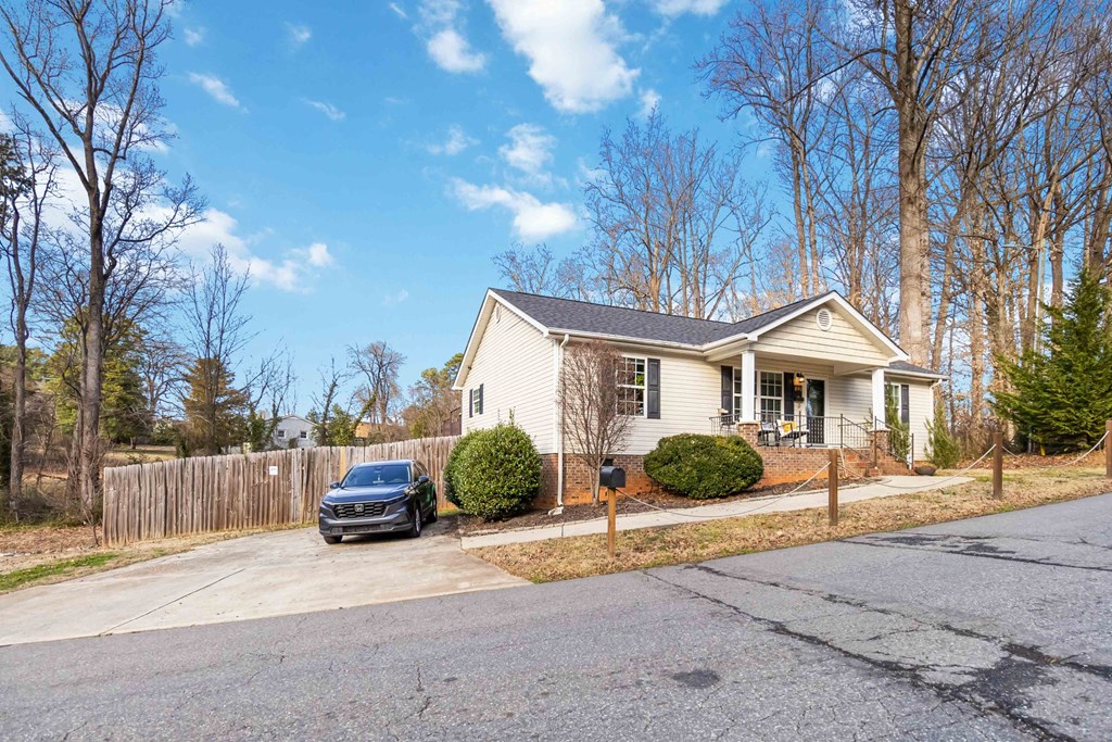 A house with a car parked in front.