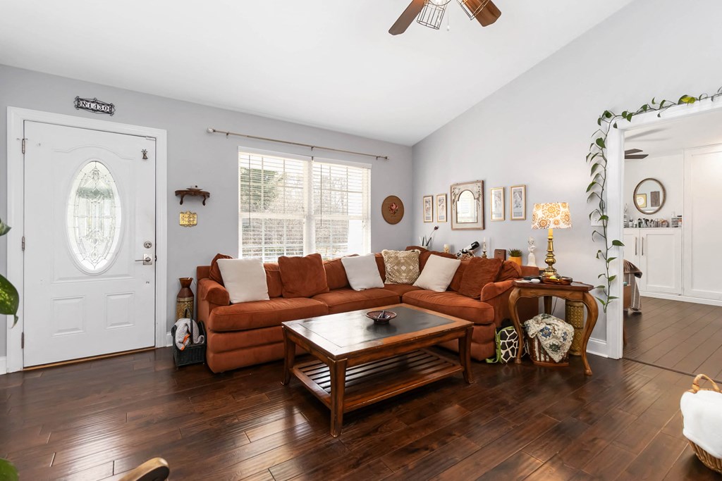 A living room with a brown sofa and a wooden coffee table.