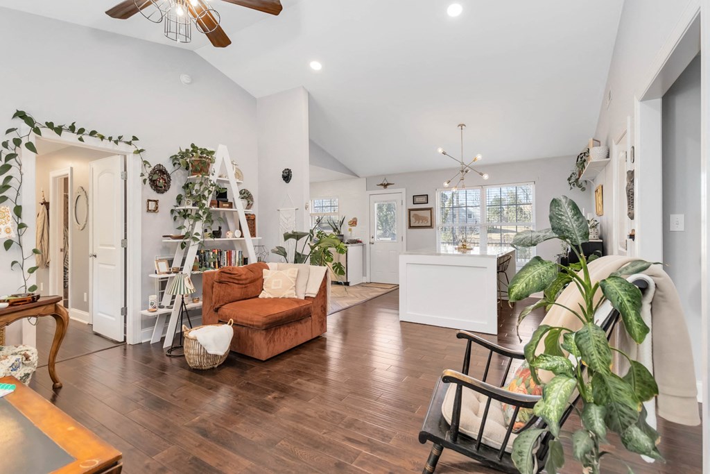 A living room with a brown couch and a wooden table.