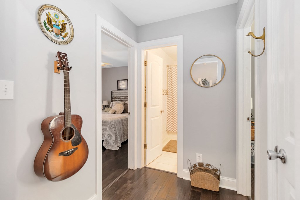 A room with a guitar hanging on the wall.