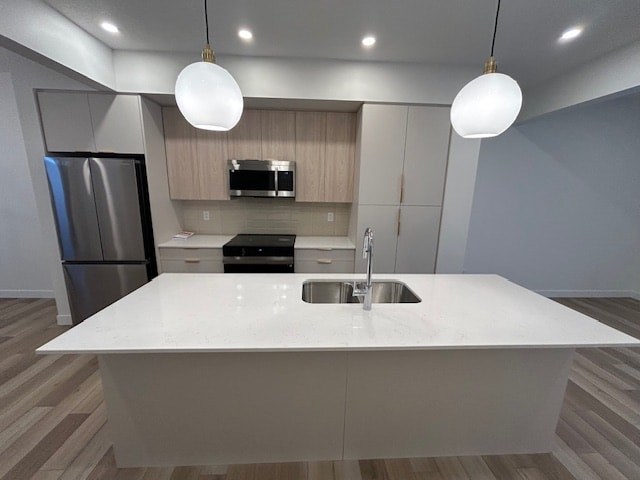 A modern kitchen with a white countertop and stainless steel appliances.