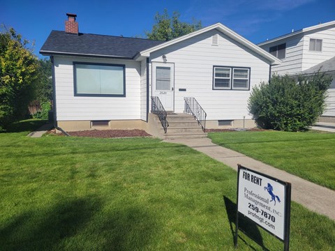 A house with a sign in front that says "108 RENT".