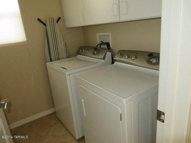 A small white washer and dryer in a laundry room.