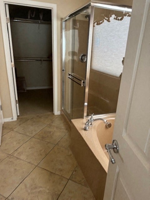 A bathroom with a walk-in shower and a sink.