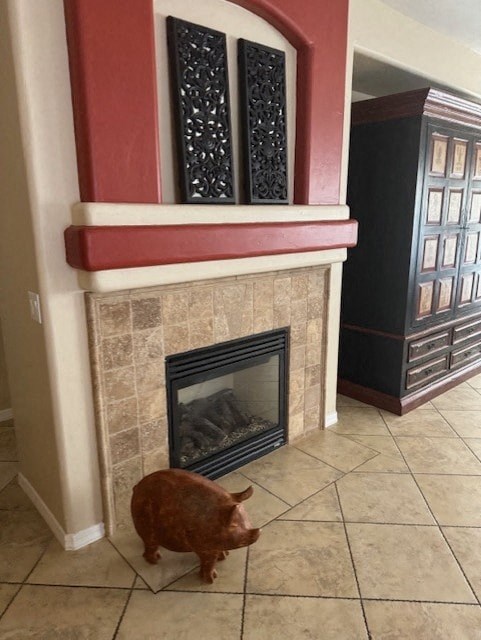 A dog is standing in front of a fireplace.