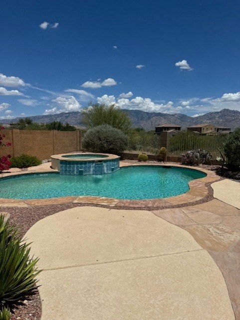 A small pool surrounded by a concrete patio.