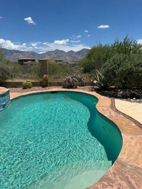 A swimming pool with a mountainous background.