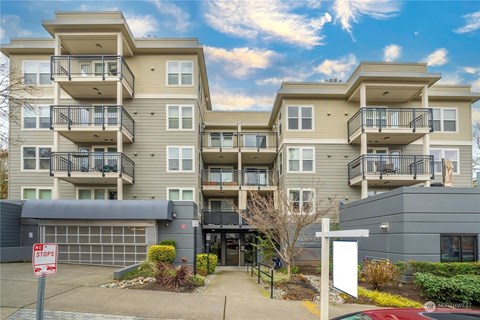 A large apartment complex with a stop sign in front.