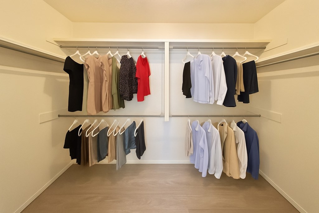Clothes hanging on a rack in a room.