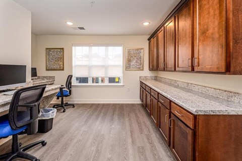 A room with wood floors and a desk with a computer.