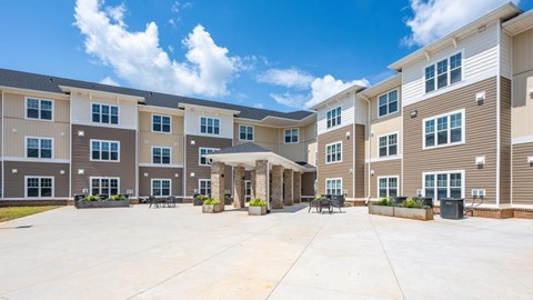 A large apartment complex with a central courtyard and multiple buildings.