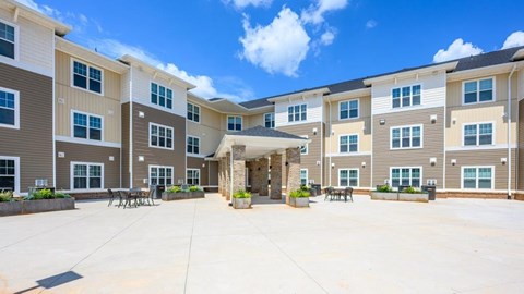 A sunny day at the courtyard of a multi-story apartment building.