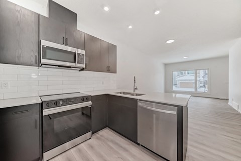 A modern kitchen with a stainless steel oven and microwave.