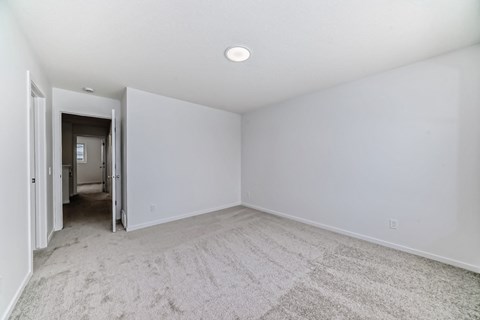 A room with white walls and a carpeted floor.