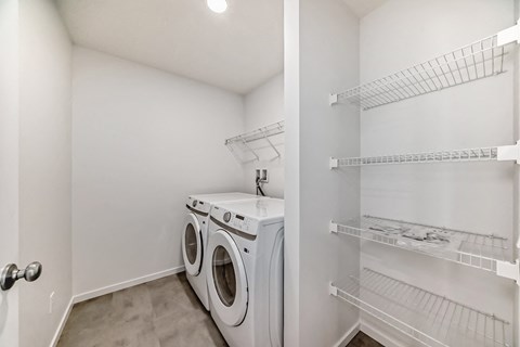 A white laundry room with a washer and dryer.