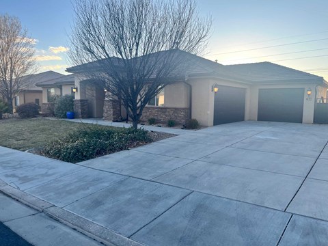 A house with a driveway and garage doors.