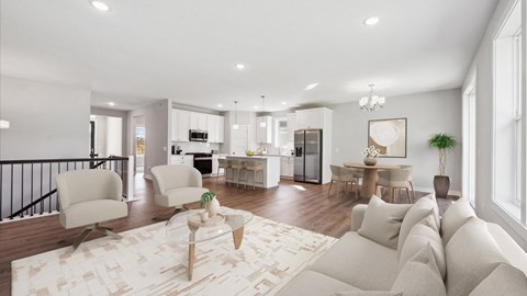 A modern living room with a white sofa set and a patterned rug.