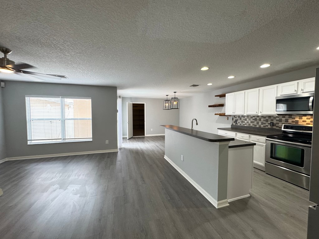 A kitchen with a stove top oven and a microwave.