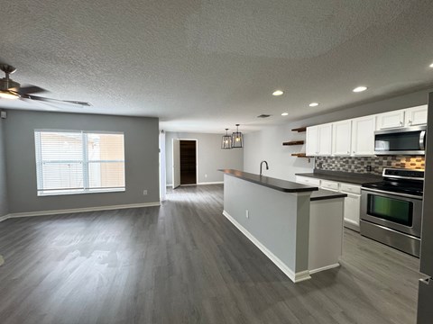 A kitchen with a stove top oven and a microwave.