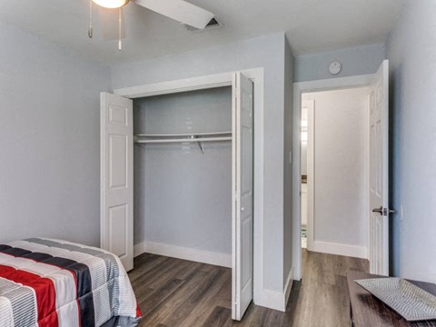 A bedroom with a bed and a closet.