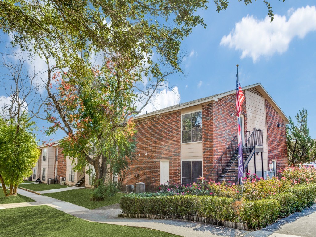 A red brick building with a flag on the front.