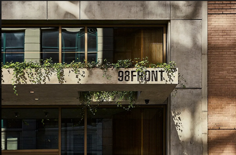 A building with a sign that reads "98FRONT".