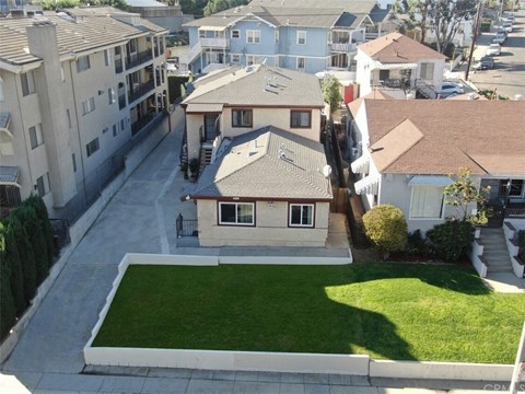 A residential area with houses and a green lawn.