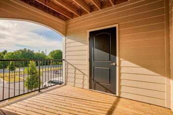 A balcony with a black door and a black railing at Mode at Melbourne, LLC Apartments, Melbourne, FL, 32901